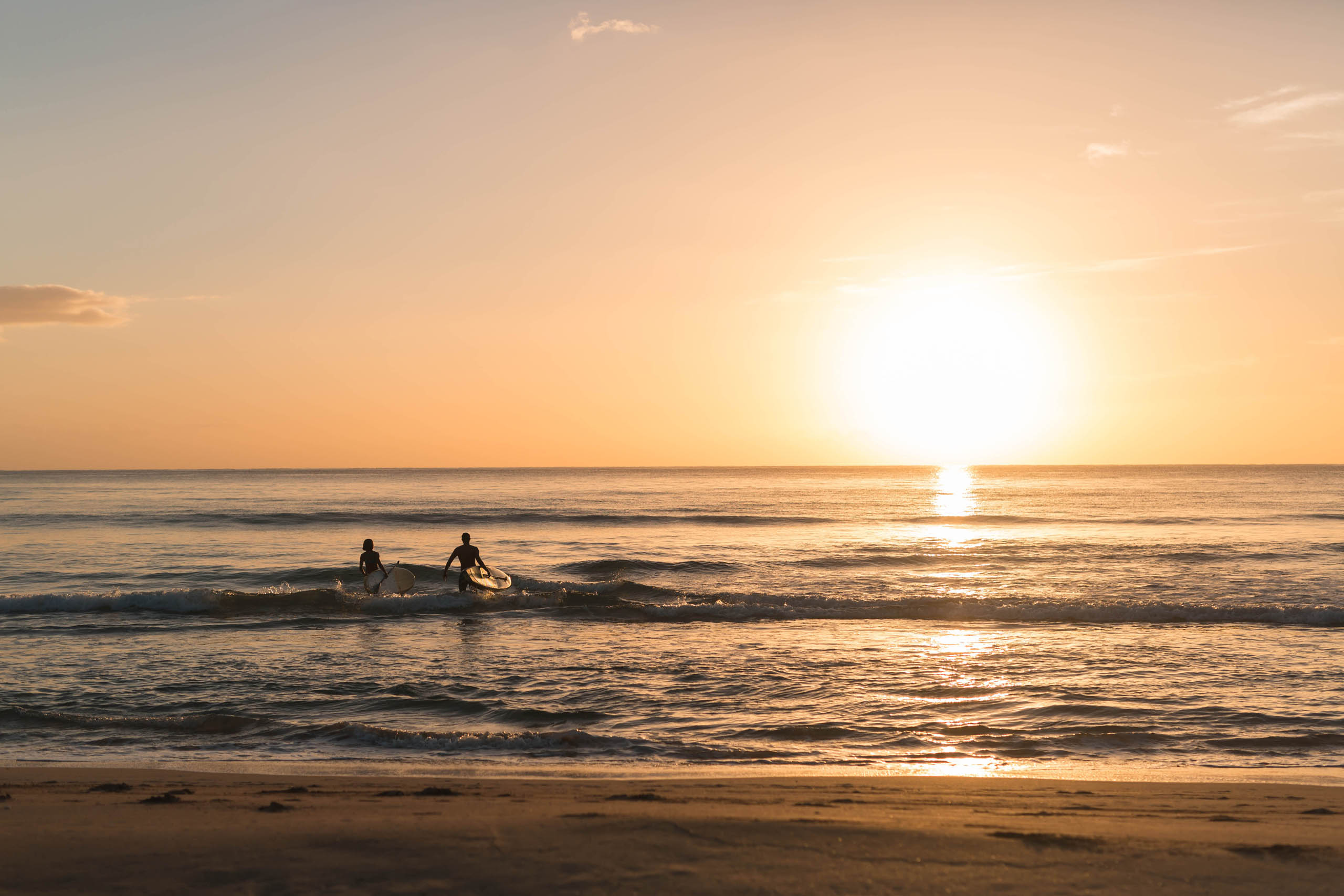 Attractive and fit surfing couple enjoy a day on the Hawaiian breaks